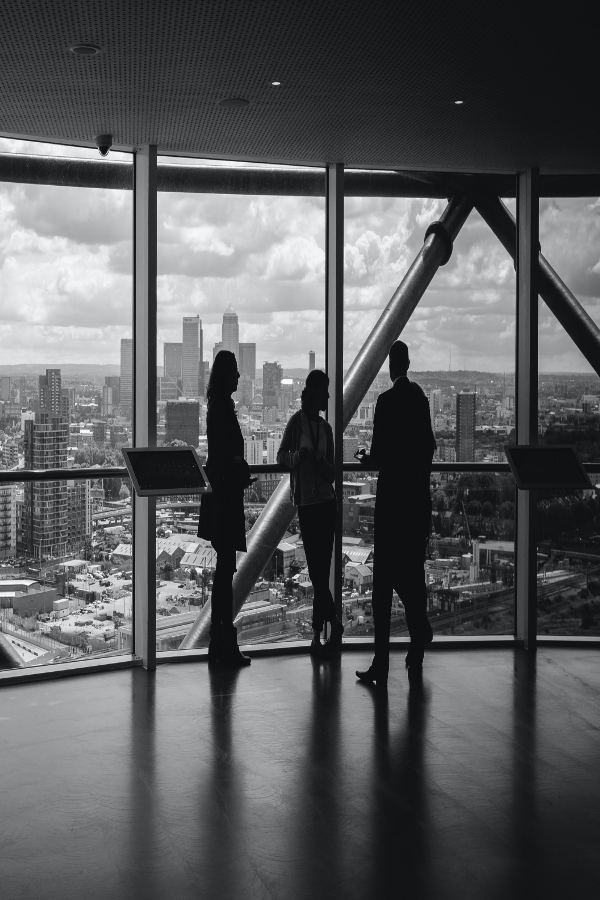 executives having a conversation in a high rise office building