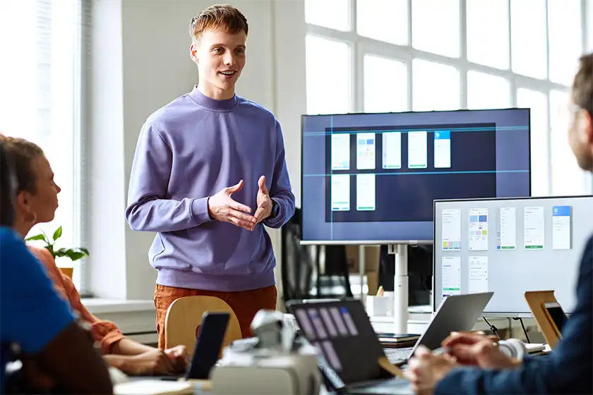 employee leading meeting at his desk